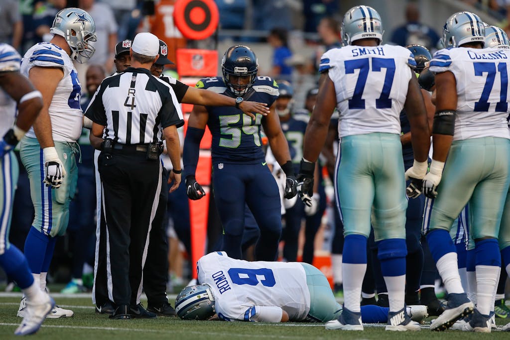 SEATTLE, WA - AUGUST 25: Quarterback Tony Romo #9 of the Dallas Cowboys lies on the turf after being injured in the first quarter during a preseason game against the Seattle Seahawks at CenturyLink Field on August 25, 2016 in Seattle, Washington. (Photo by Otto Greule Jr/Getty Images)