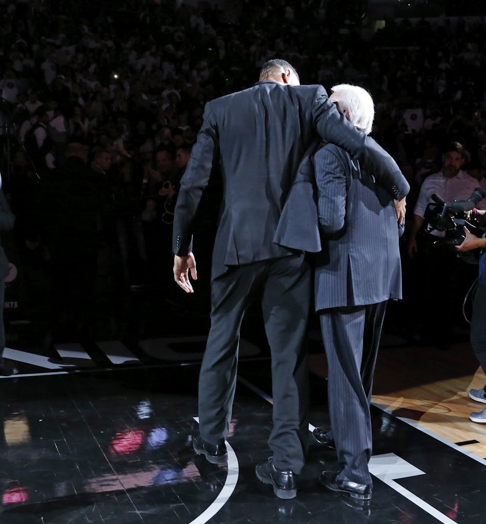 SAN ANTONIO,TX - DECEMBER 18: Tim Duncan hugs San Antonio head coach Gregg Popovic at the end of the ceremony as the two walk off the court when his number was retired after the game against the New Orleans Pelicans. Honoring and retiring of Tim Duncan number at AT&T Center on December 18, 2016 in San Antonio, Texas. NOTE TO USER: User expressly acknowledges and agrees that , by downloading and or using this photograph, User is consenting to the terms and conditions of the Getty Images License Agreement. (Photo by Ronald Cortes/Getty Images)