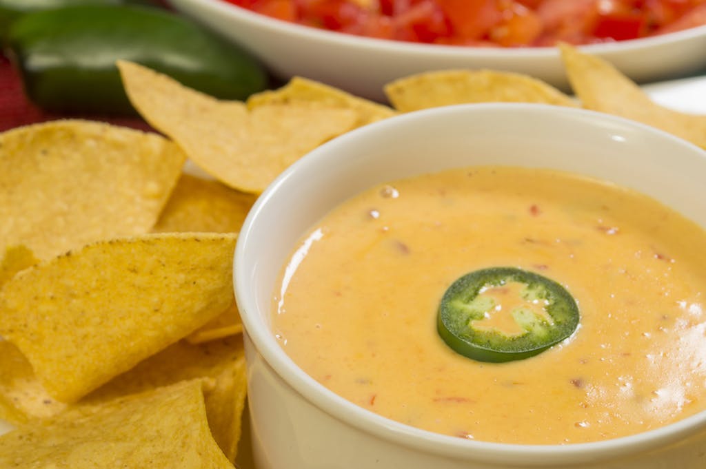 A hot bowl of so-called "cheese dip" with tortilla chips.
