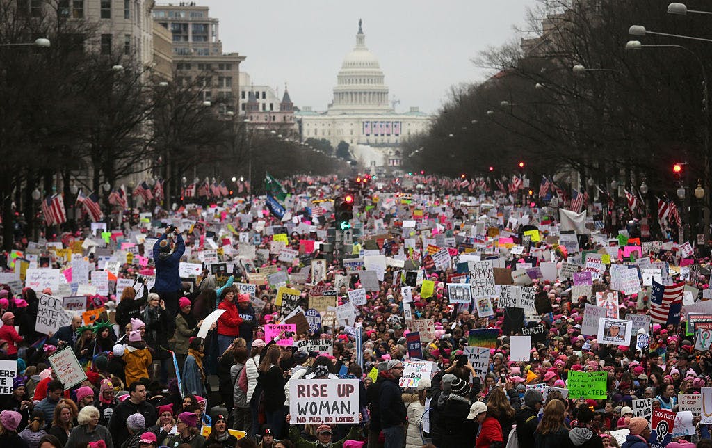 WASHINGTON, DC - JANUARY 21: Protesters walk during the Women's March on Washington, with the U.S. Capitol in the background, on January 21, 2017 in Washington, DC. Large crowds are attending the anti-Trump rally a day after U.S. President Donald Trump was sworn in as the 45th U.S. president.