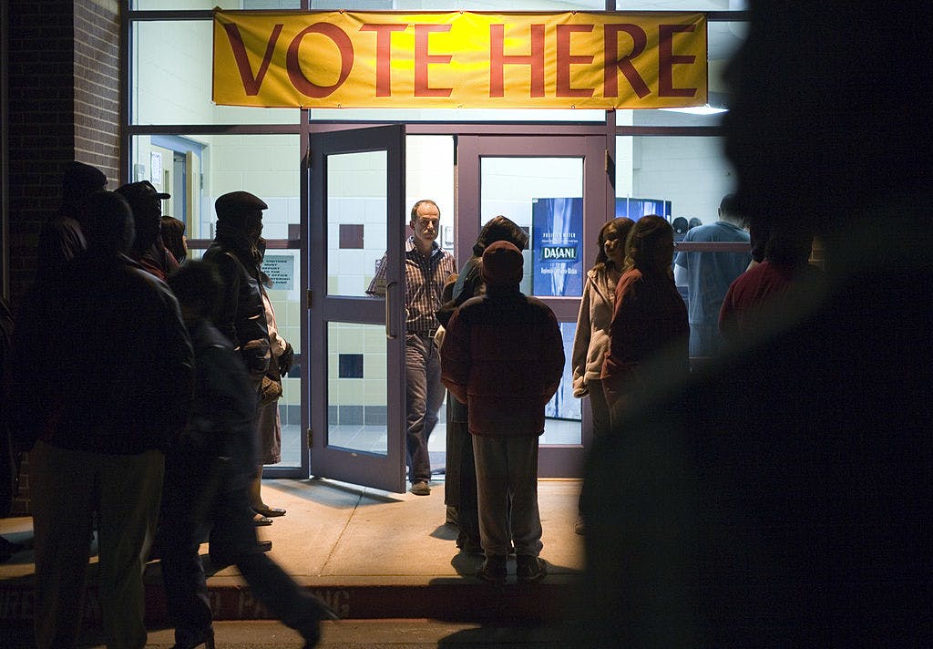 Voters wait outside of DeSoto East Middle School just before 9:00 p.m. March 4, 2008 in DeSoto, a suburb of Dallas, Texas.