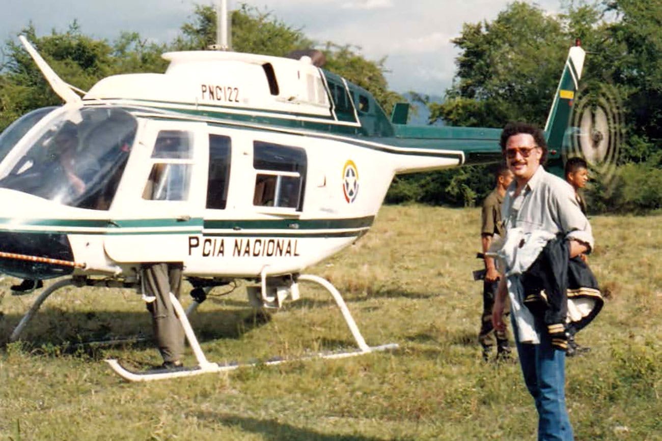 Javier Peña in front of a Colombian National Police helicopter.