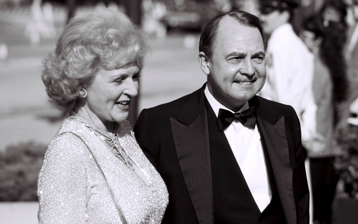 Black and white photo of John Hillerman Magnum P.I. with Betty White.