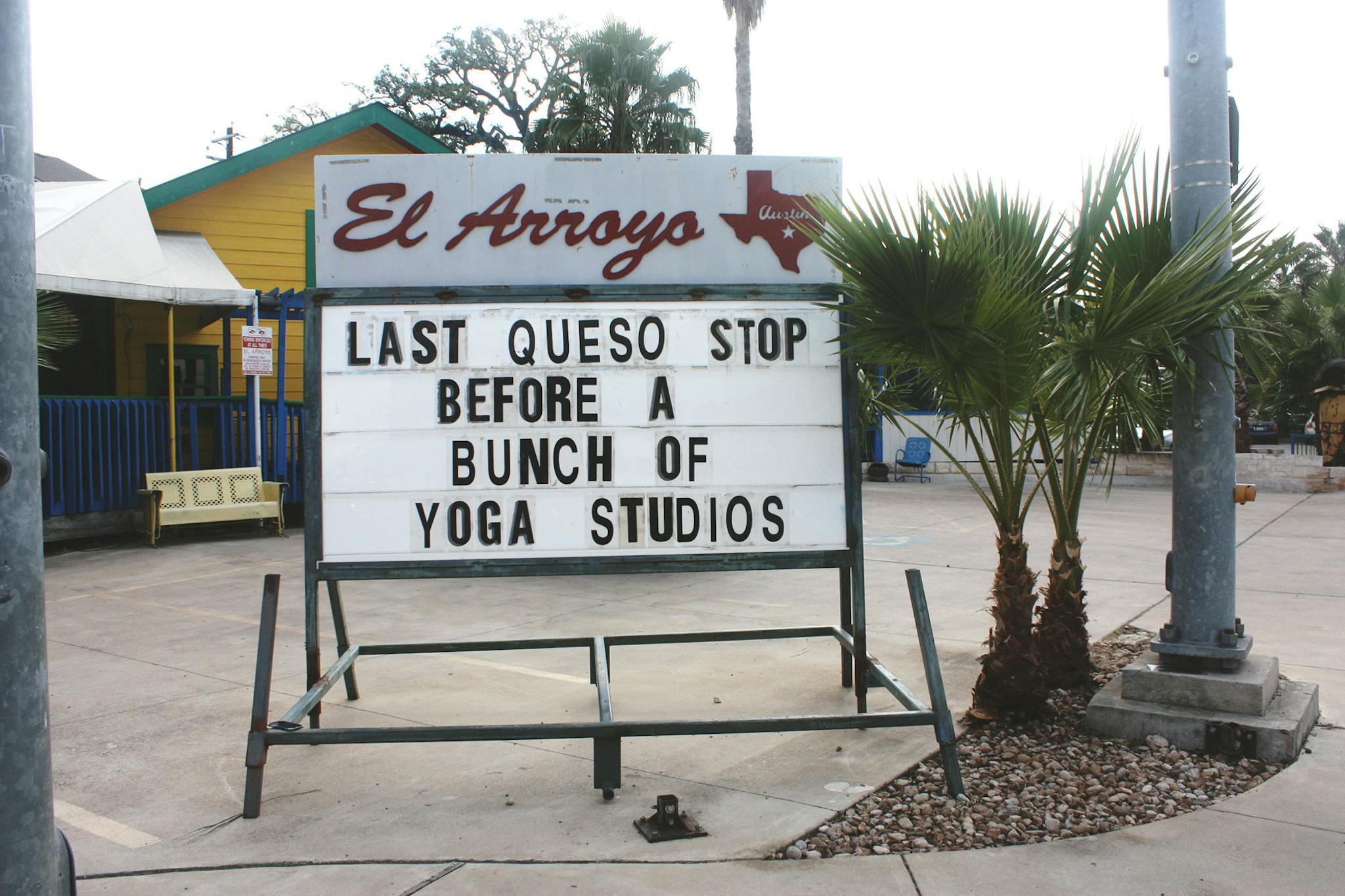 El Arroyo sign says last queso stop before a bunch of yoga studios.