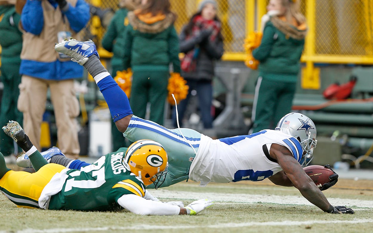 Dallas Cowboys receiver Dez Bryant (88) lunges for the end zone as Green Bay Packers cornerback Sam Shields (37) defends in an NFL divisional playoff football game Sunday, January 11, 2015 at Lambeau Field in Green Bay, Wisconsin.