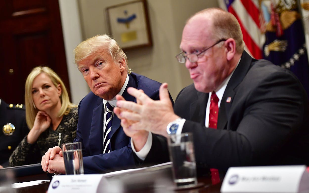 President Donald Trump (C) at the White House on March 20, 2018 in Washington, D.C., joined by Homeland Security Secretary Kirstjen Nielsen (L) and Thomas Homan, acting director of Immigration and Customs Enforcement.
