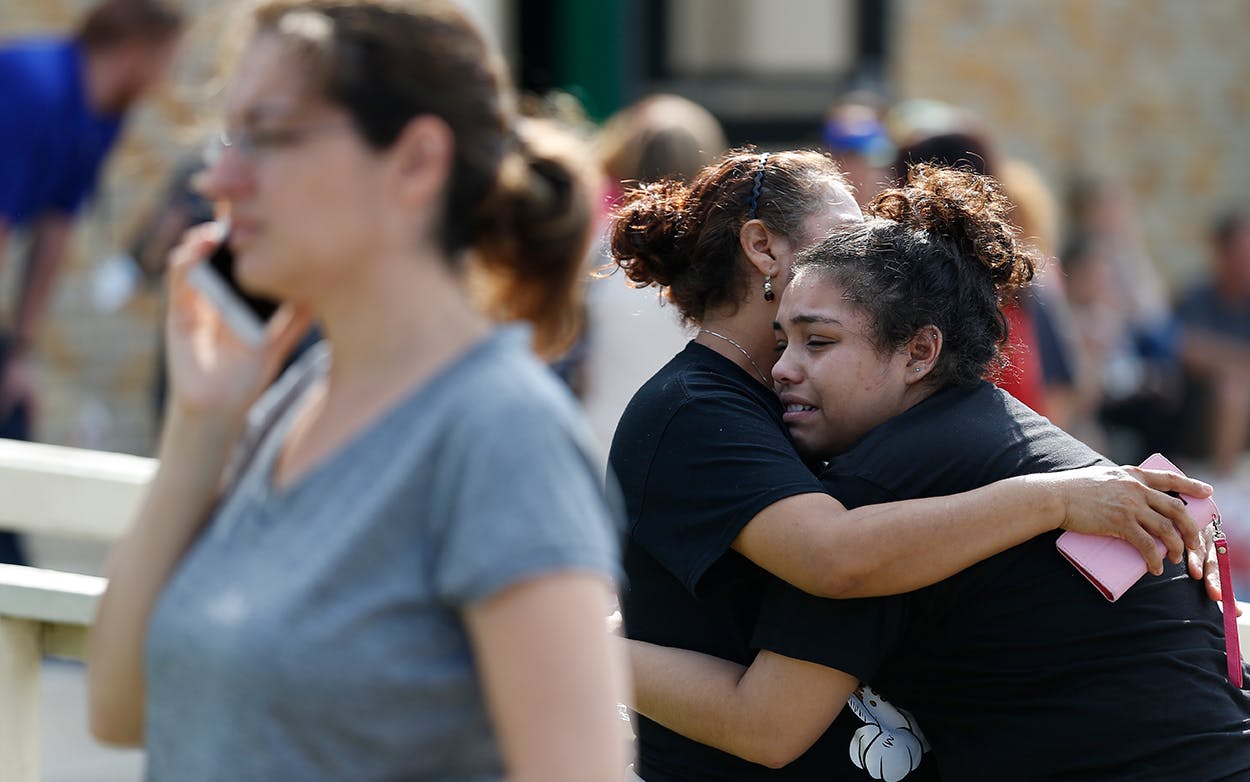 Santa Fe High School junior Guadalupe Sanchez, 16, cries in the arms of her mother, Elida Sanchez, after reuniting with her at a meeting point at a nearby Alamo Gym fitness center following a shooting at Santa Fe High School in Santa Fe, Texas, on Friday, May 18, 2018.