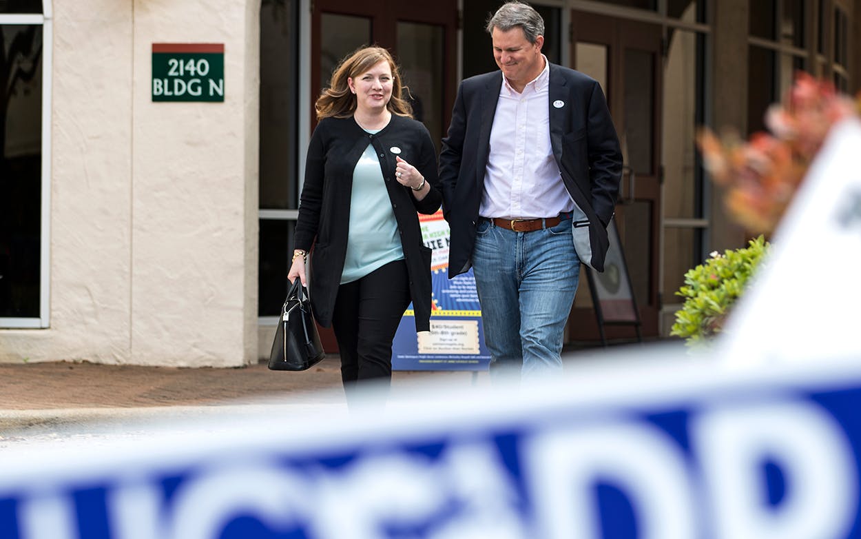 In this March 6, 2018, photo, Lizzie Pannill Fletcher and her husband, Scott Fletcher, walk out of the polling place at St. Anne's Catholic Church after voting in the primary election in Houston. Fletcher is up against Laura Moser in the Texas 7th Congressional District democratic primary runoff Tuesday, May 22, 2018.