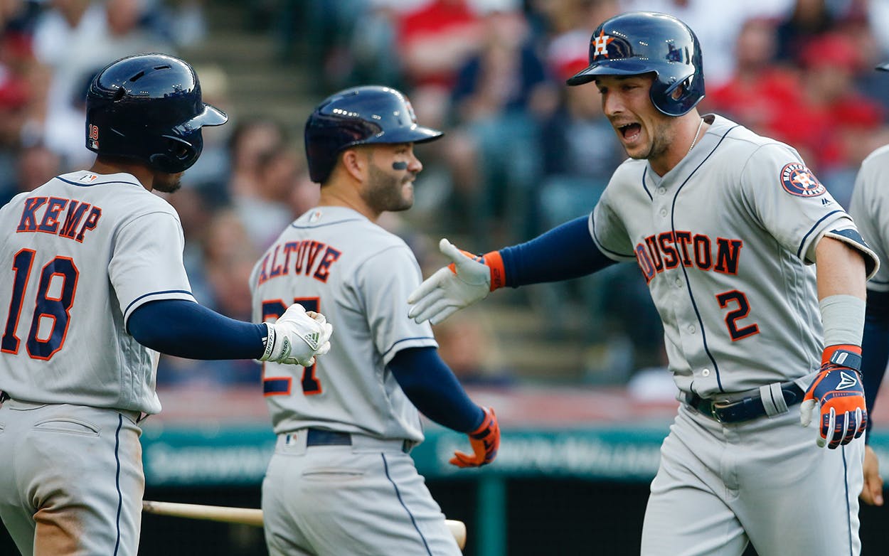 Alex Bregman #2 of the Houston Astros celebrates with Jose Altuve #27 and Tony Kemp #18 after hitting a three run home run off Mike Clevinger #52 of the Cleveland Indians during the fifth inning at Progressive Field on May 24, 2018 in Cleveland, Ohio.