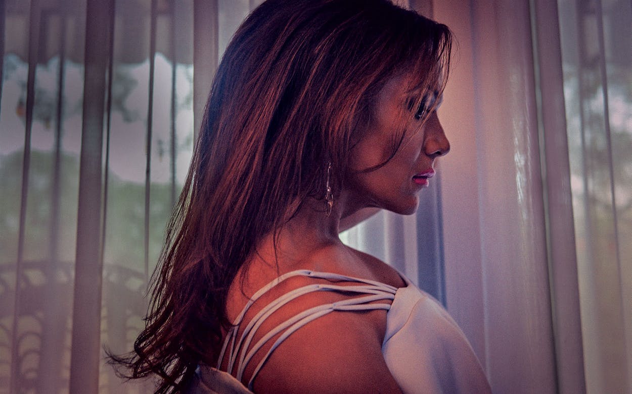 Side profile of Aliah Hernandez in dim lighting.