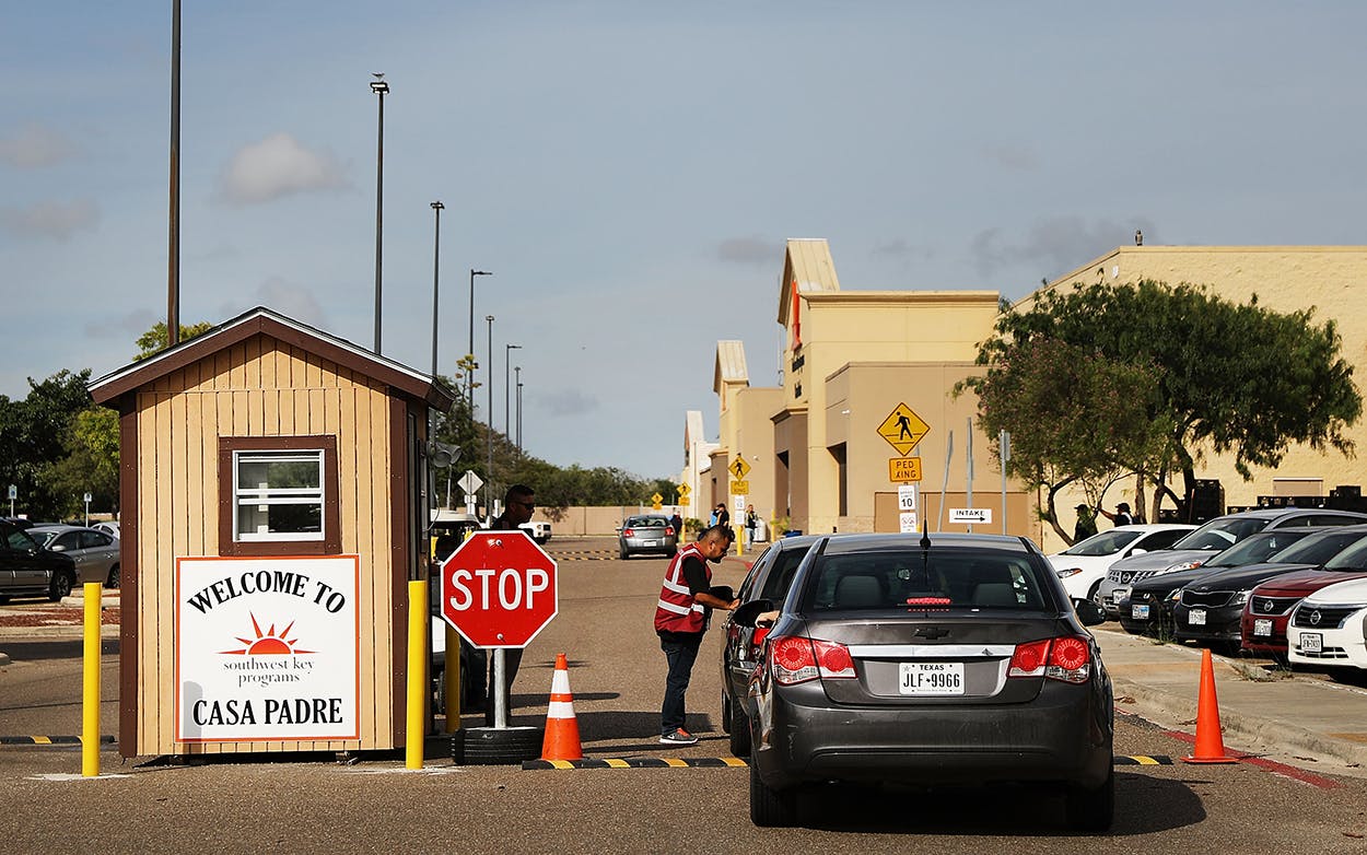 A security guard checks cars at the entrance to Casa Padre, a former Walmart which is now a center for unaccompanied immigrant children on June 24, 2018 in Brownsville, Texas.