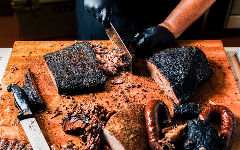 Pitmaster and co-owner Matt Lowery of LJ's BBQ in Brenham prepares a smoked brisket taco.