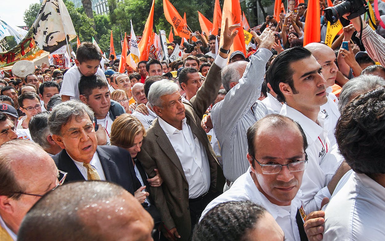 Presidential candidate Andres Manual Lopez Obrador of the leftist Party of Democratic Revolution (PRD) marches with supporters to his final campaign rally on June 27, 2012 in Mexico City, Mexico.