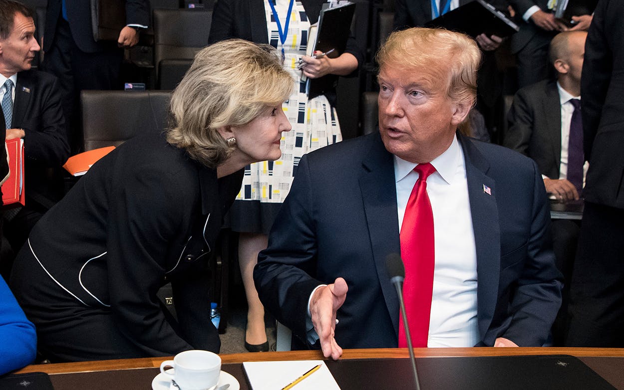 Kay Bailey Hutchison, United States Permanent Representative to NATO, speaks with President Donald Trump at the first work session of the North Atlantic council at the NATO Summit in Belgium on July 11, 2018.