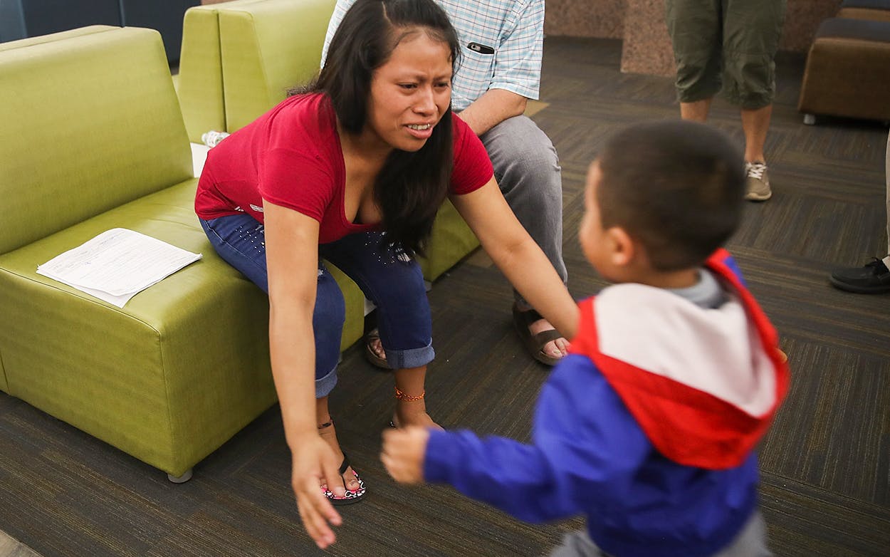 A woman, identified only as Maria, reaches for her son Franco, 4, as they are reunited at the El Paso International Airport on July 26, 2018 in El Paso.