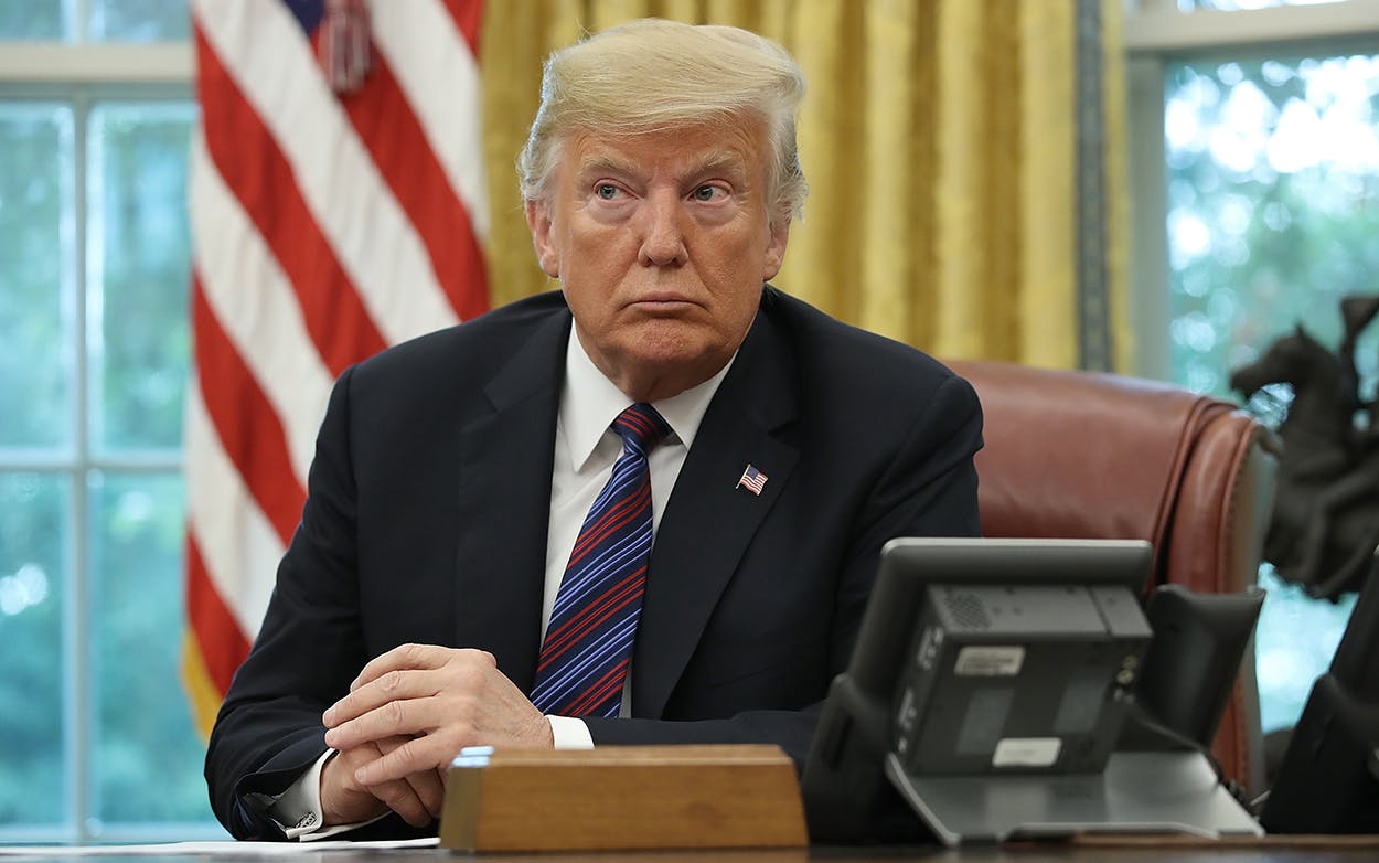 U.S. President Donald Trump speaks on the telephone via speakerphone with Mexican President Enrique Pena Nieto in the Oval Office of the White House on August 27, 2018 in Washington, DC.