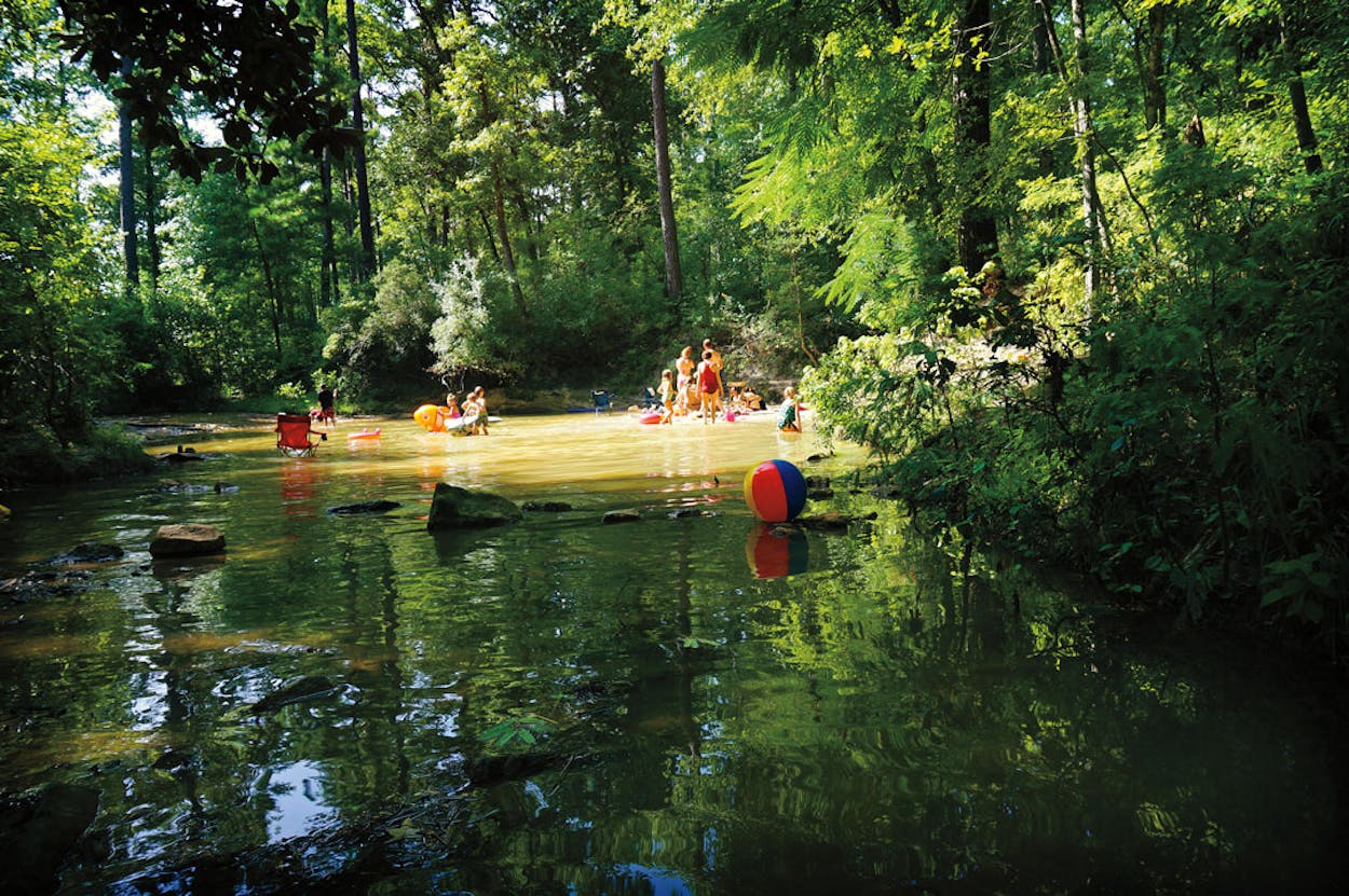 People enjoying the water at the shaded and secluded Boykin Springs.