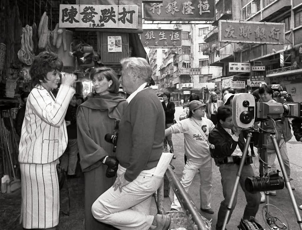 Producer Leonard Katzman discusses a scene with Gray and Principal while shooting for Dallas in Hong Kong.