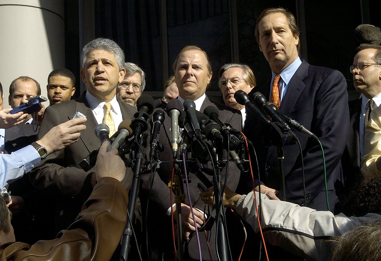 Former Enron CEO Jeff Skilling, flanked by his lawyers, Dan Petrocelli (L) and Bruce Hiler (R) talk to the media outside the federal courthouse after being indicted on several charges connected with the fall of Enron February 19, 2004 in Houston.