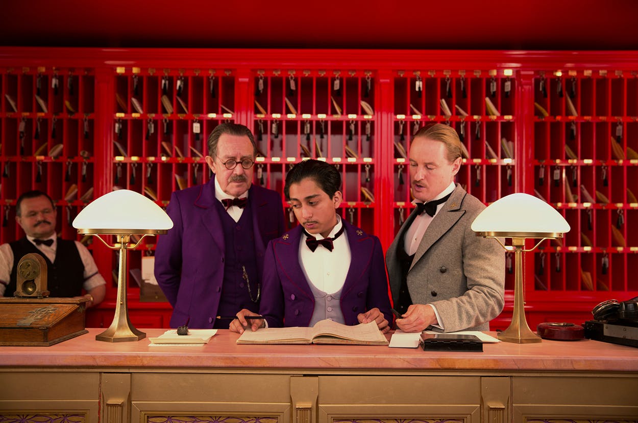 Tony Revolori (center, as Zero) and Owen Wilson (right, as Chuck) in the 2014 film "The Grand Budapest Hotel."