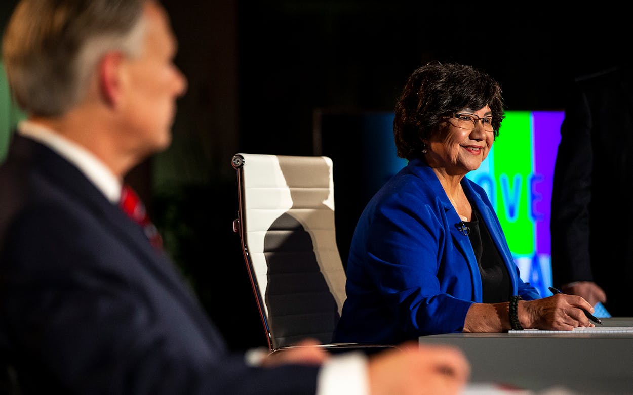 Democratic candidate for governor Lupe Valdez, right, smiles before a debate against Gov. Greg Abbot, left, at the LBJ Library in Austin on Friday, Sept. 28, 2018.