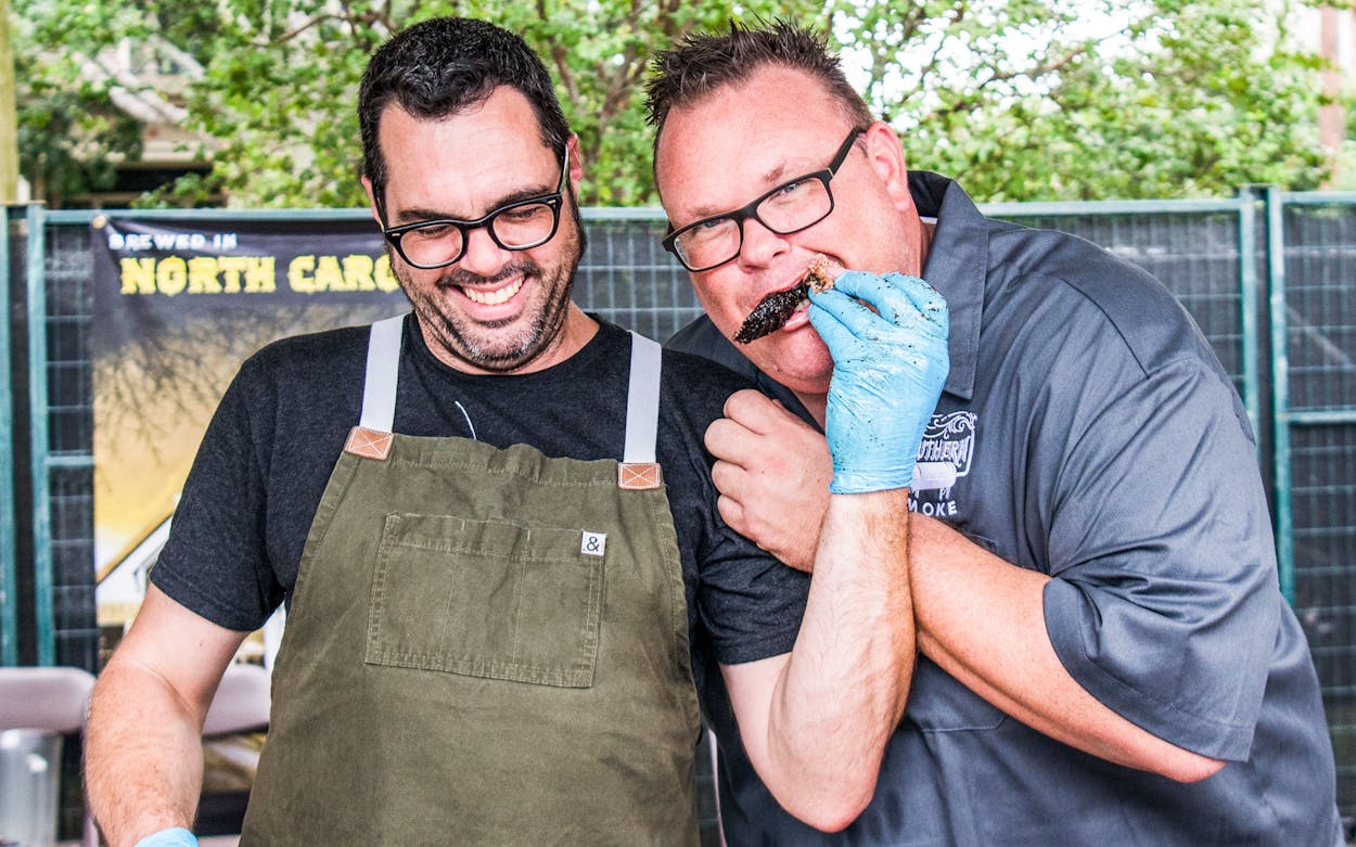 Aaron Franklin of Austin’s Franklin Barbecue lets Southern Smoke co-founder and curator Chris Shepherd sample some of his brisket during the event that raised $425,000 for charity on September 30, 2018 in Houston.
