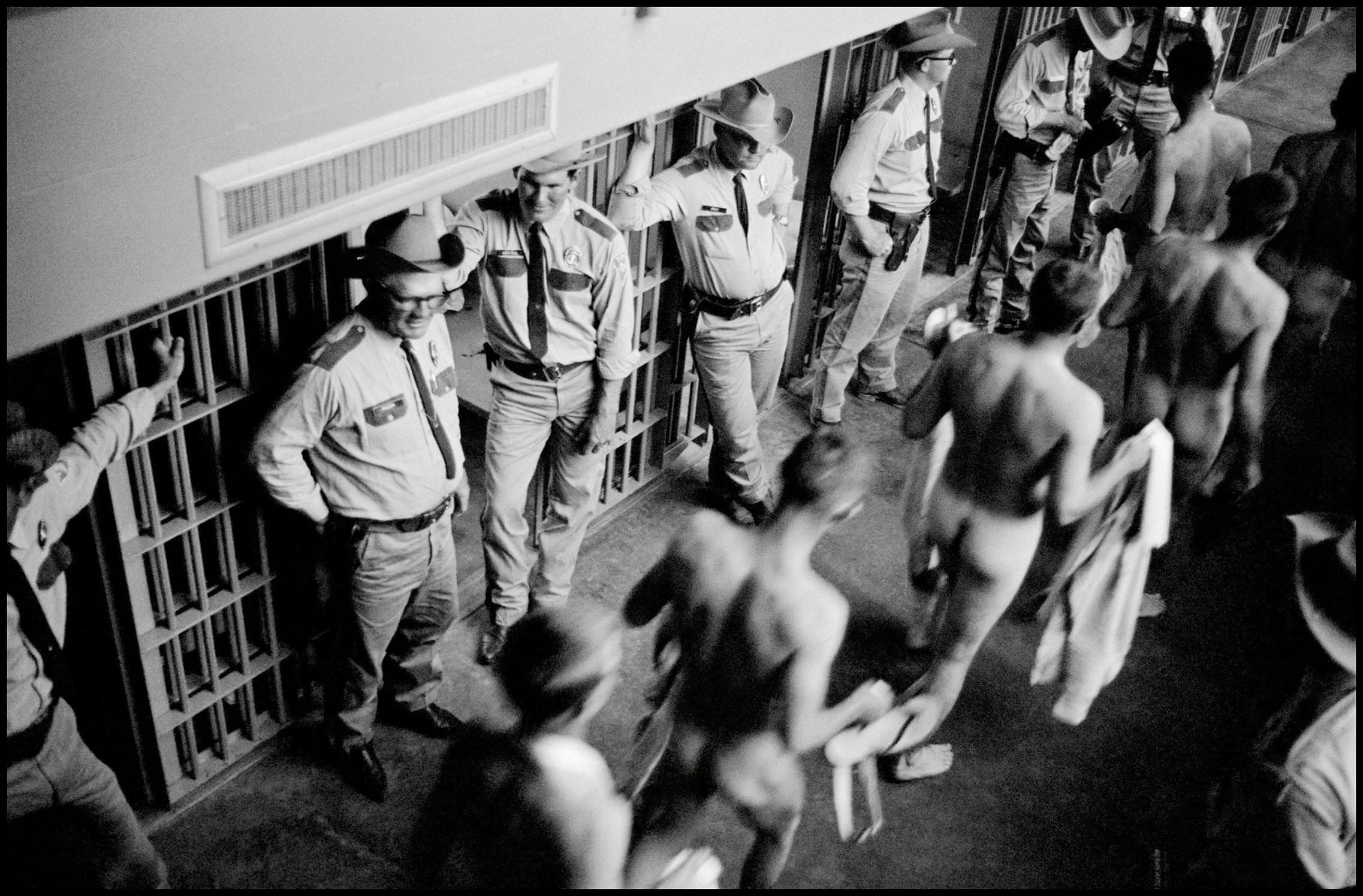 Naked prisoners receiving a shakedown at Ellis. 