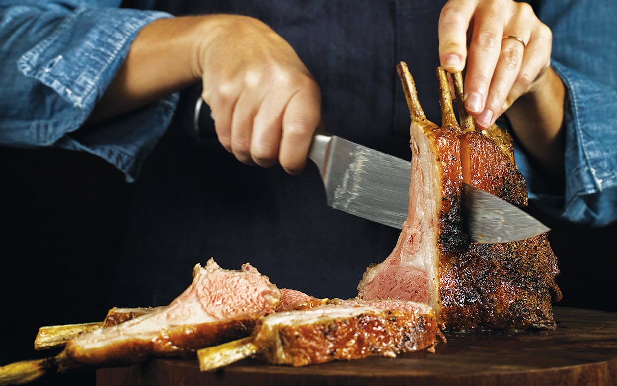 Food stylist Meghan Erwin slices a sumac-crusted rack of lamb.