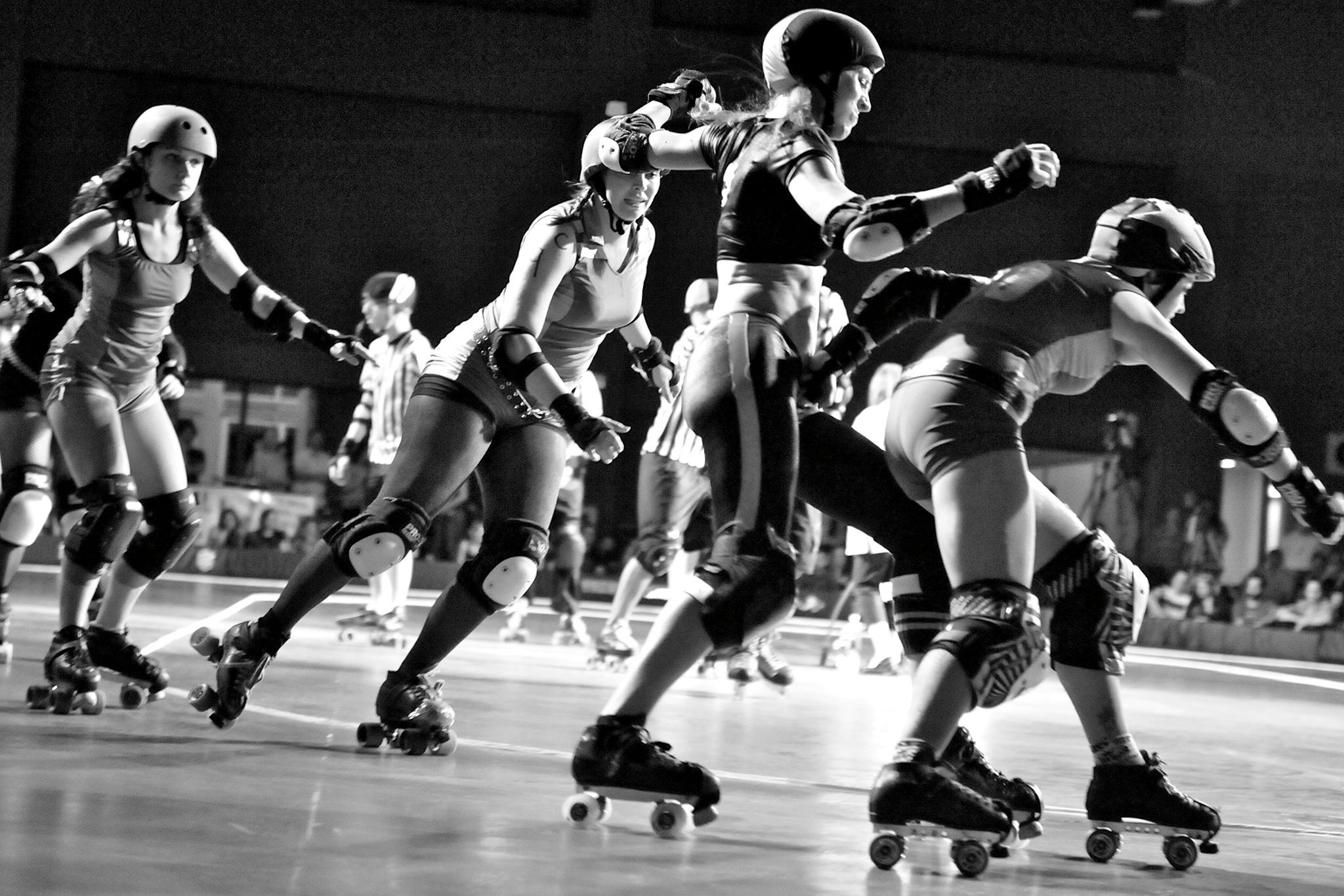 Players Chasing Amy, Babe Ruthless, Voodoo Doll, and Molotov M. Pale during a roller derby bout