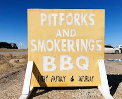 The sign for Pitforks and Smokerings BBQ along Highway 84