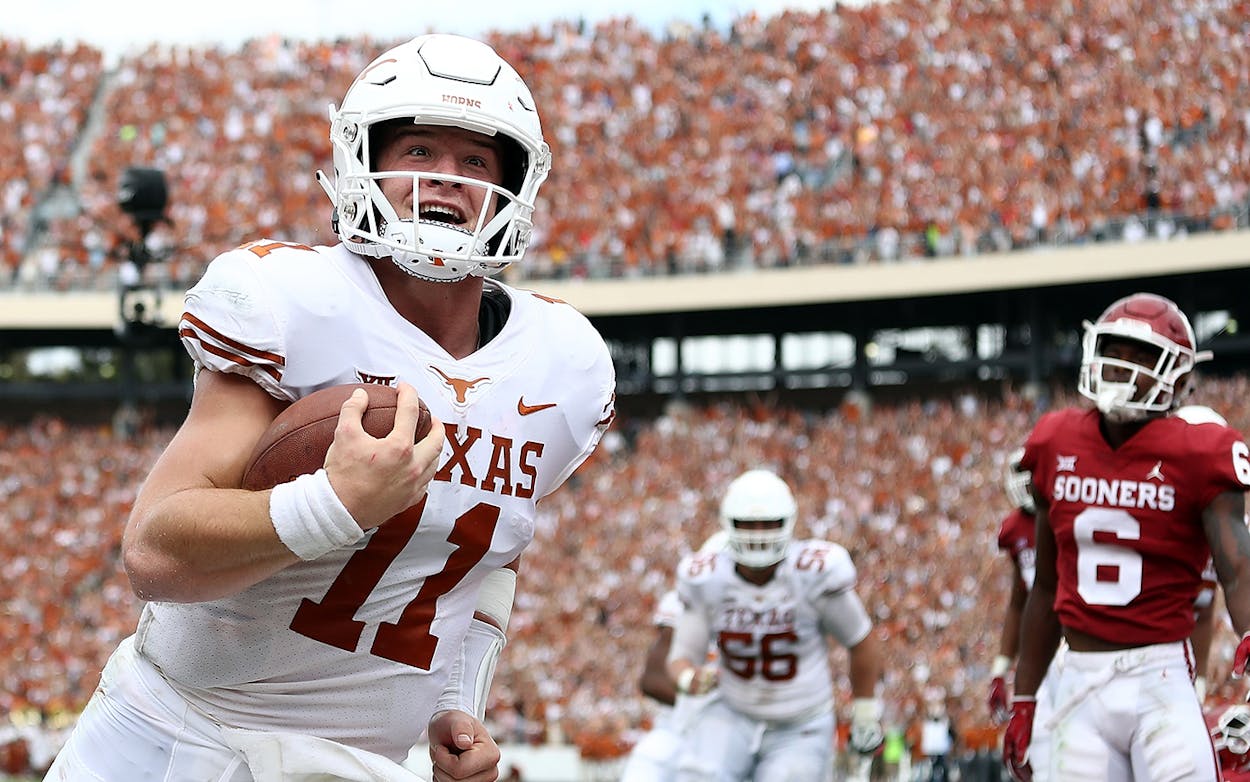 Sam Ehlinger #11 of the Texas Longhorns smiles as he runs into the endzone for a touchdown against the Oklahoma Sooners in the second quarter of the 2018 AT&T Red River Showdown at Cotton Bowl on October 6, 2018 in Dallas.