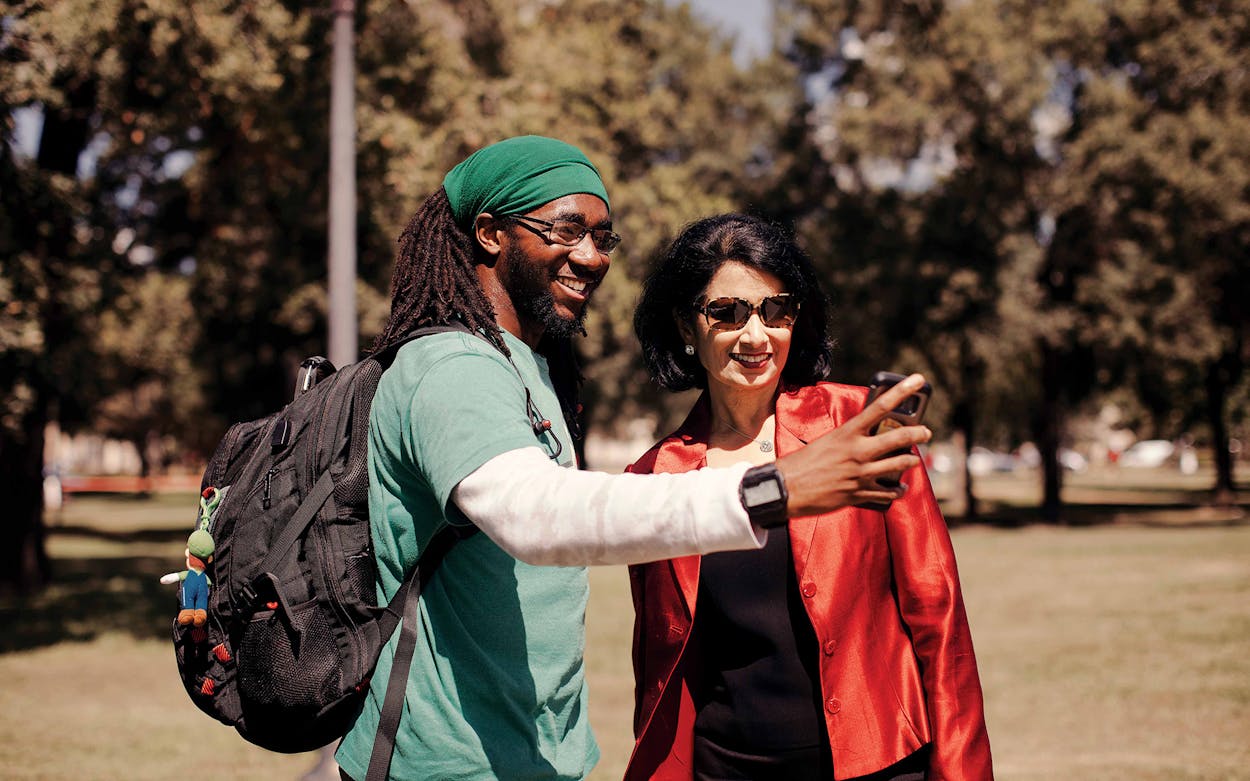 Khator stops for a selfie with a student while walking across the UH campus.