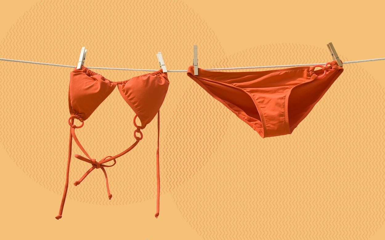 a bikini top and bottom pinned on a clothesline