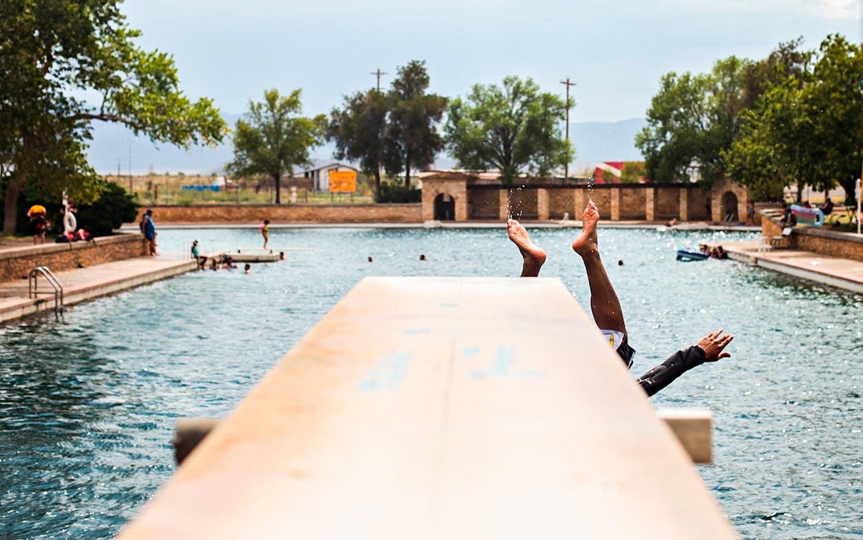 In this July 23, 2012, file photo, a swimmer dives into the spring-fed pool at Balmorhea State Park in Balmorhea, Texas.