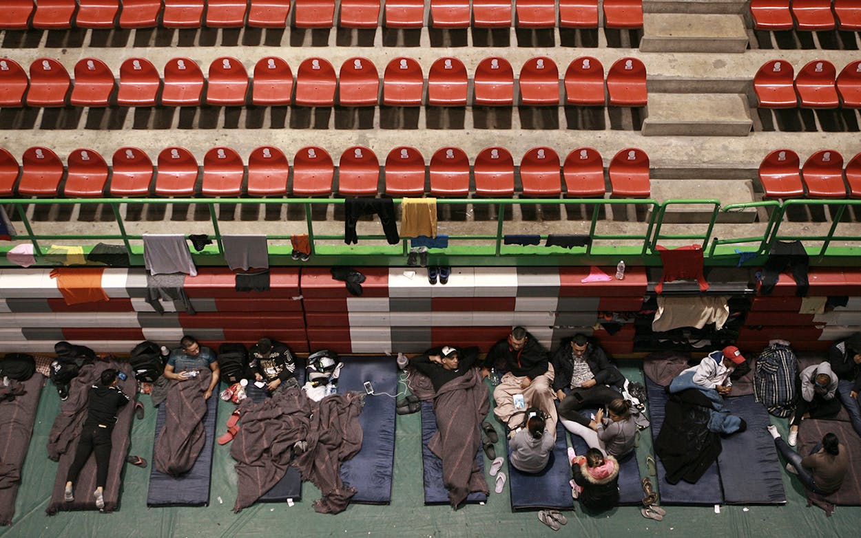 Migrants from Central America, Africa and the Caribbean, who are awaiting their turns to request asylum in the U.S., pass the time inside a shelter in Bachilleres gymnasium in Ciudad Juarez, Mexico, Tuesday, Feb. 19, 2019.