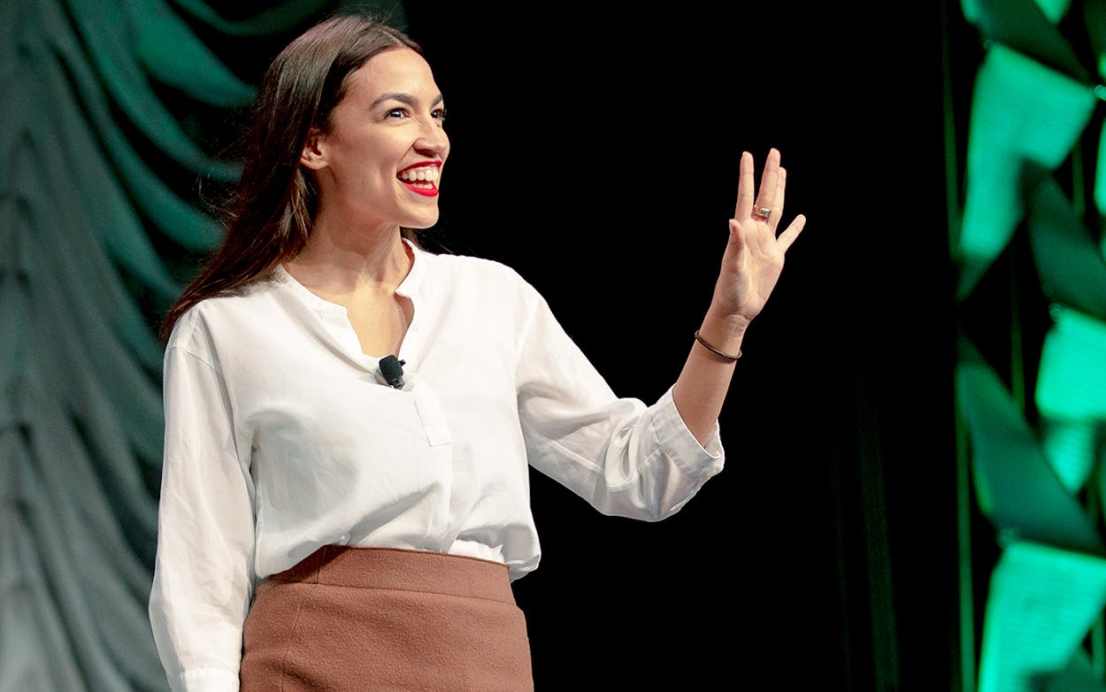 Representative Alexandria Ocasio-Cortez waves to the audience during SXSW on March 9, 2019.
