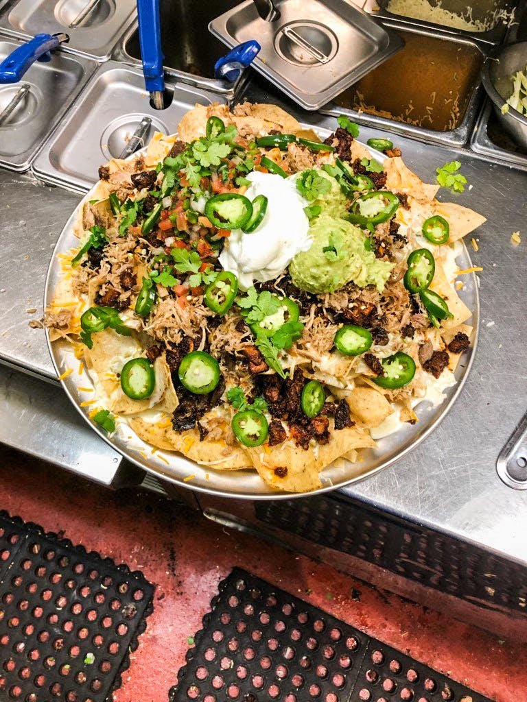 The Grande Nachos Supreme at Chispas in Austin are topped with barbacoa, duck confit and carne asada,