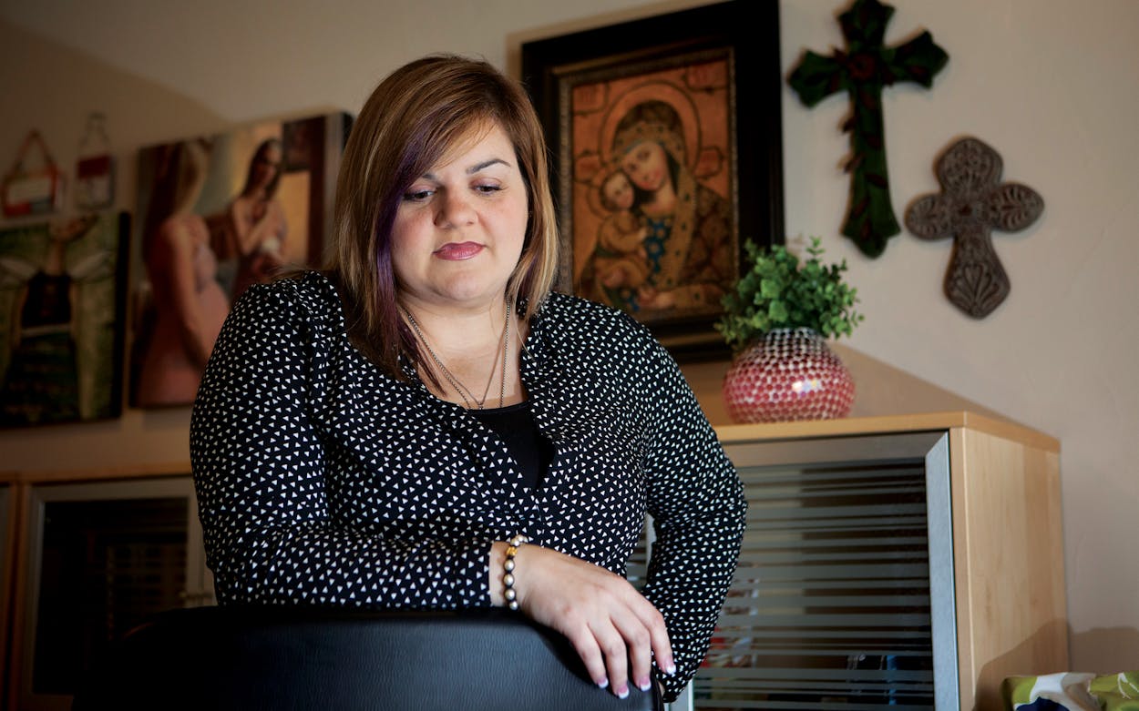 Abby Johnson in front of crosses that hang in her office.