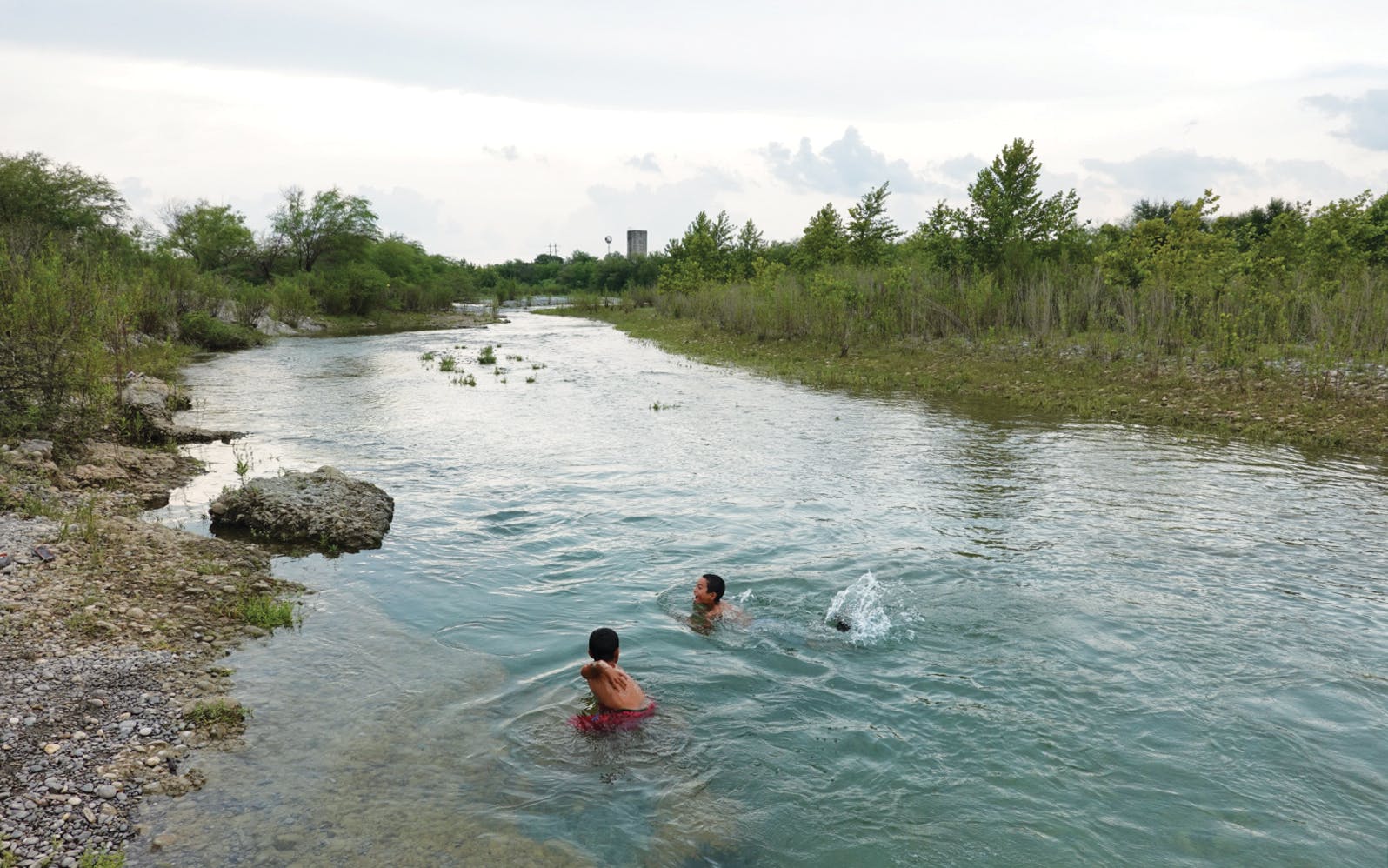 Two children swimming in the Río Sabinas river. 