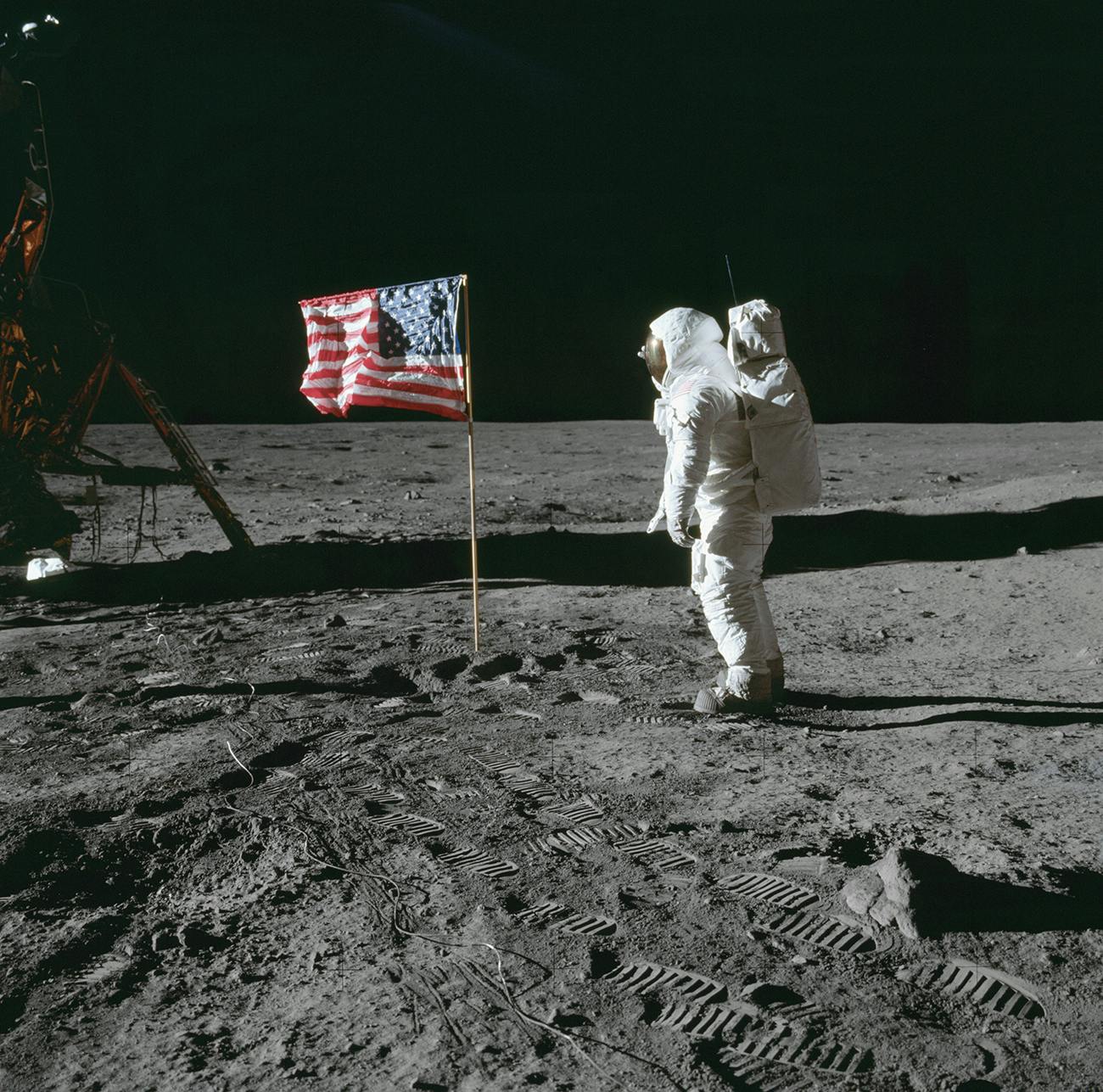 Astronaut Edwin E. Aldrin Jr., lunar module pilot of the first lunar landing mission, poses for a photograph beside the deployed U.S. flag during Apollo 11 extravehicular activity on the lunar surface on July 20, 1969.