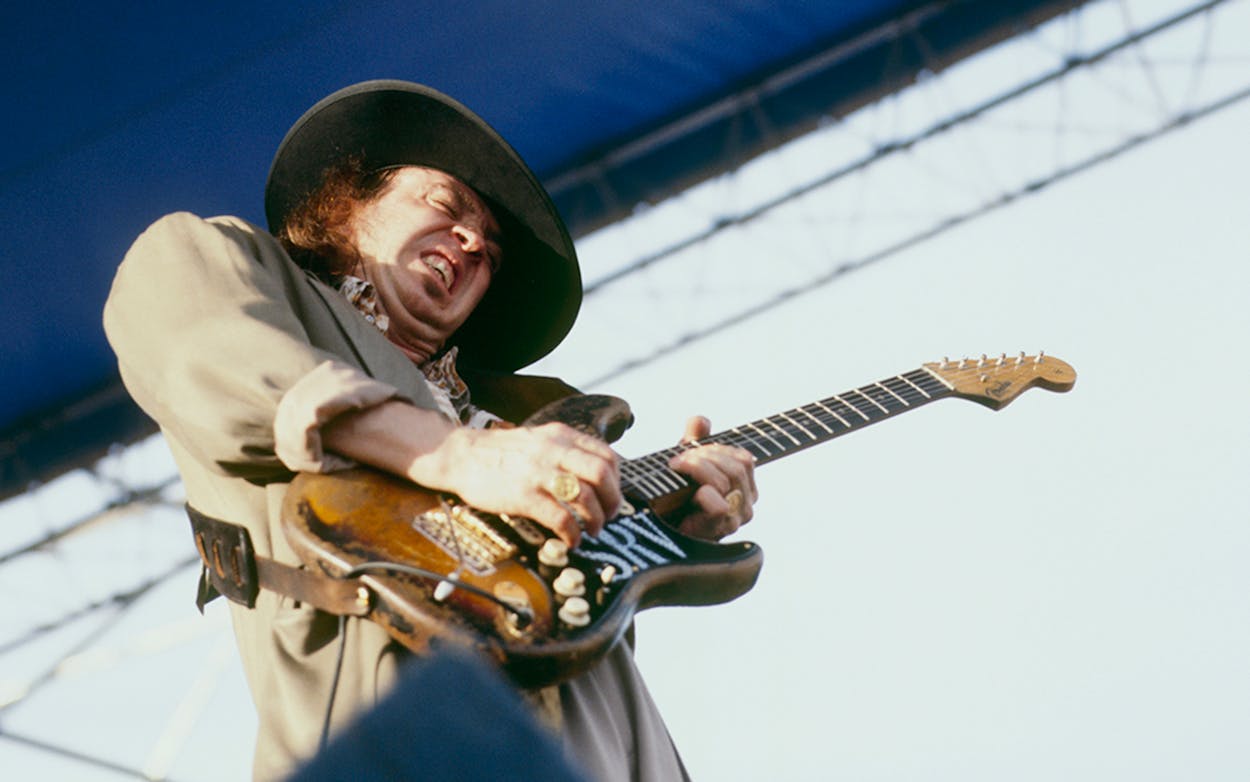 Stevie Ray Vaughn playing guitar.