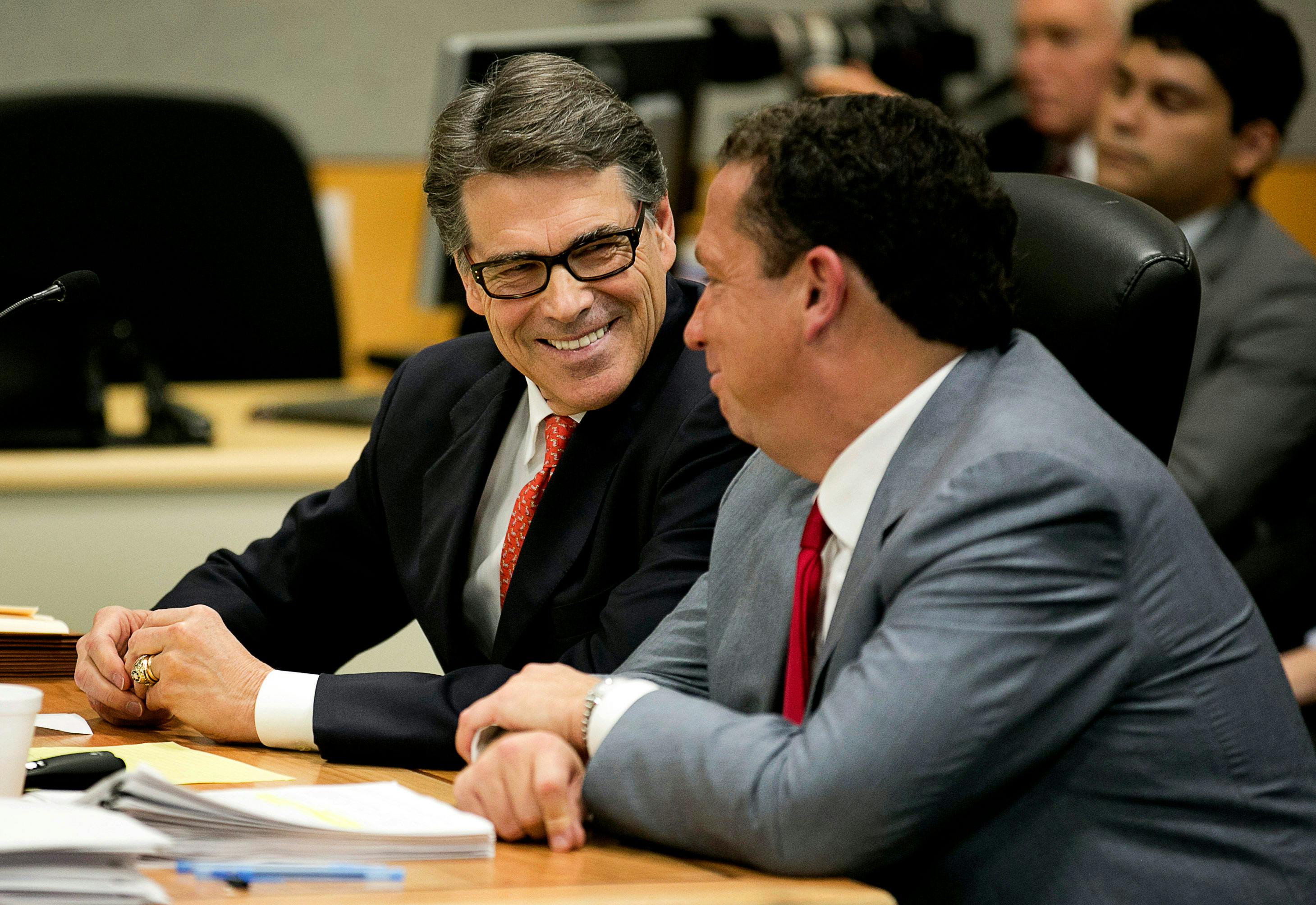 Buzbee and Rick Perry smiling together at hearing