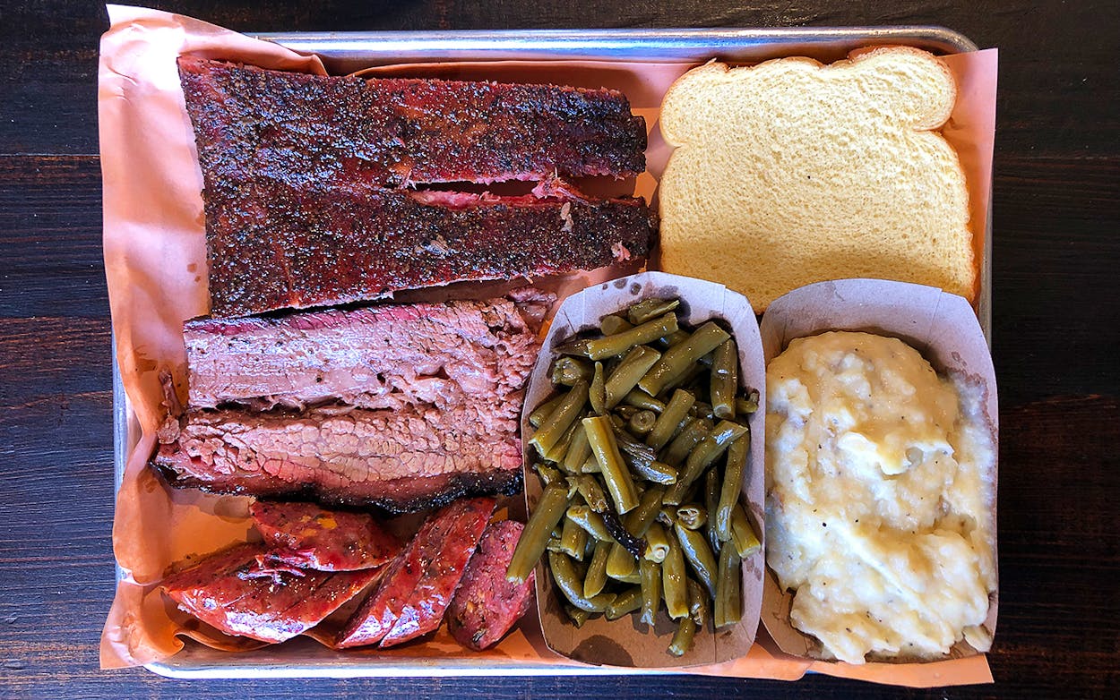 Wright's Barbecue tray with three meats, green beans, potato salad, and bread.