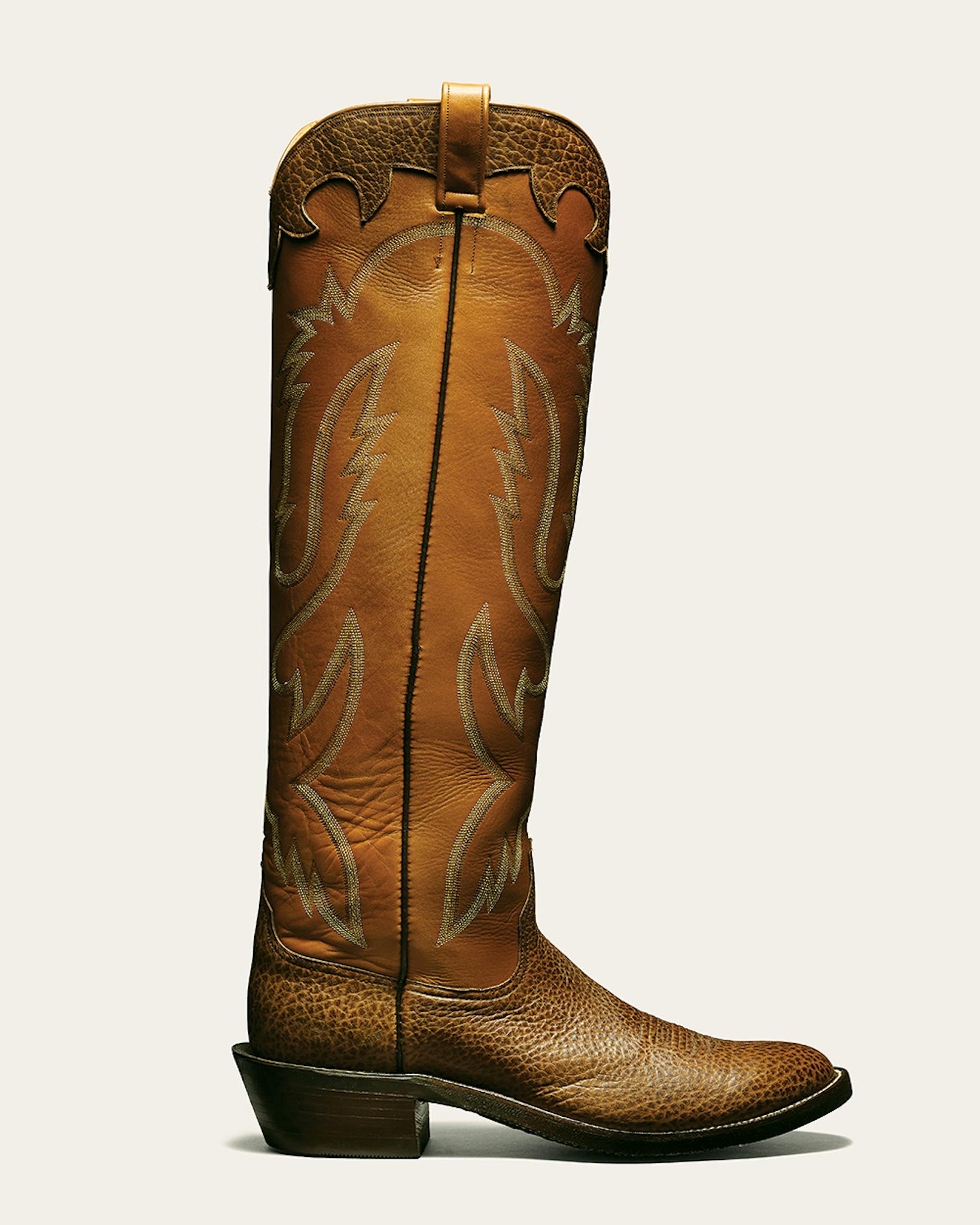 Armando's Boot Company tall, light brown cowboy boot.