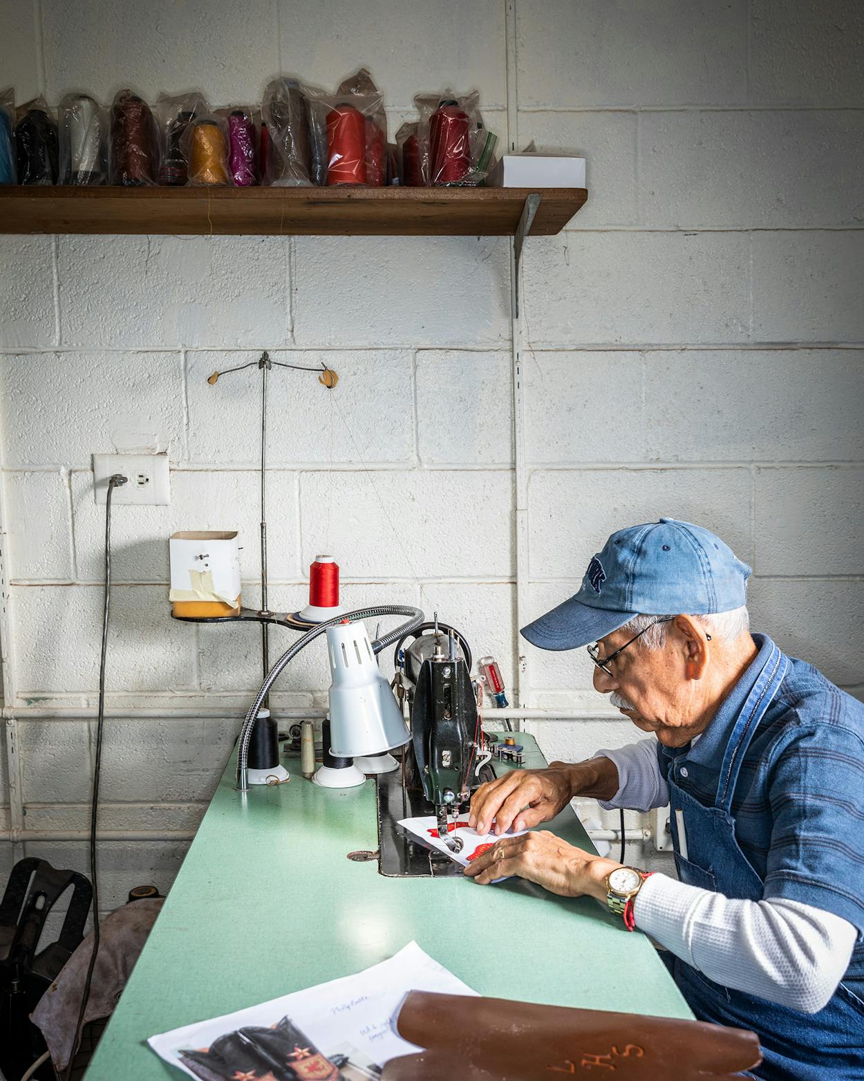 Juan O. Ortiz, who has worked at Little’s for 33 years, mans a classic Singer 31-15 sewing machine, stitching inlays that will decorate a boot’s shaft.