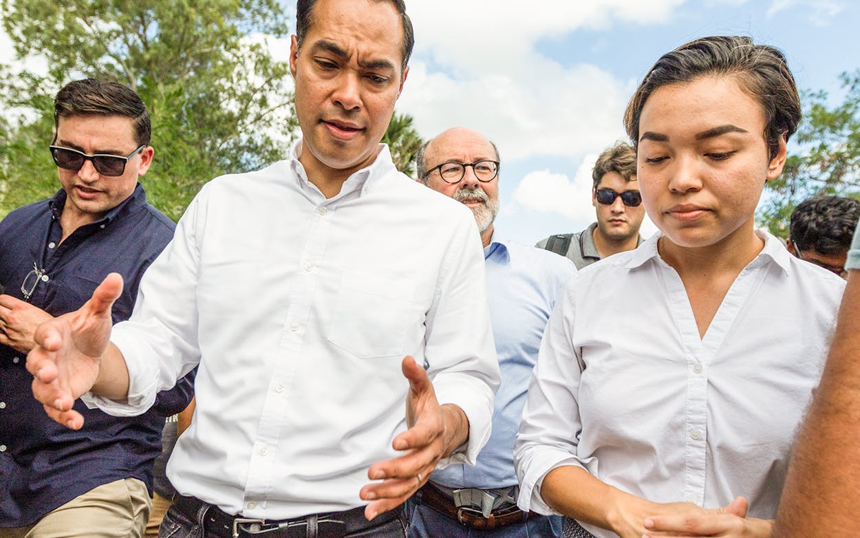 Democratic presidential candidate Julian Castro, left, asks Dani Marrero Hi about conditions for those seeking asylum Monday, Oct. 7, 2019, as they walk through a migrant campsite in Matamoros, Mexico.