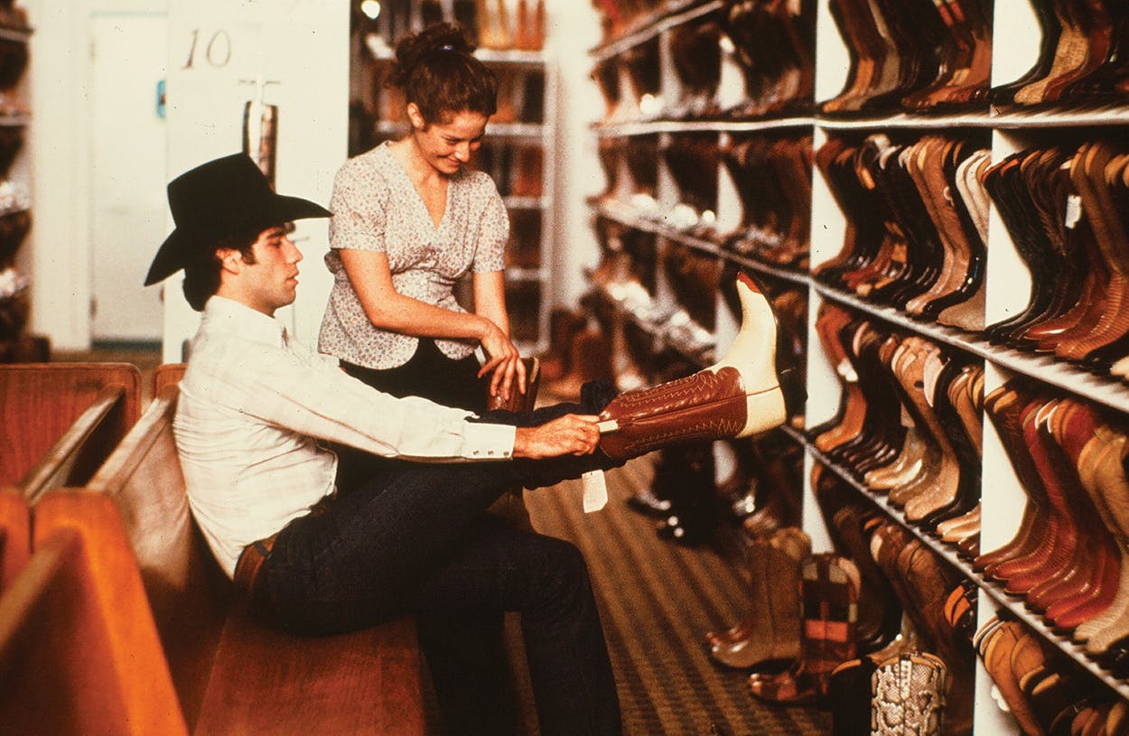 John Travolta prepping for the 1980 film Urban Cowboy, which helped spark a nationwide boot craze.