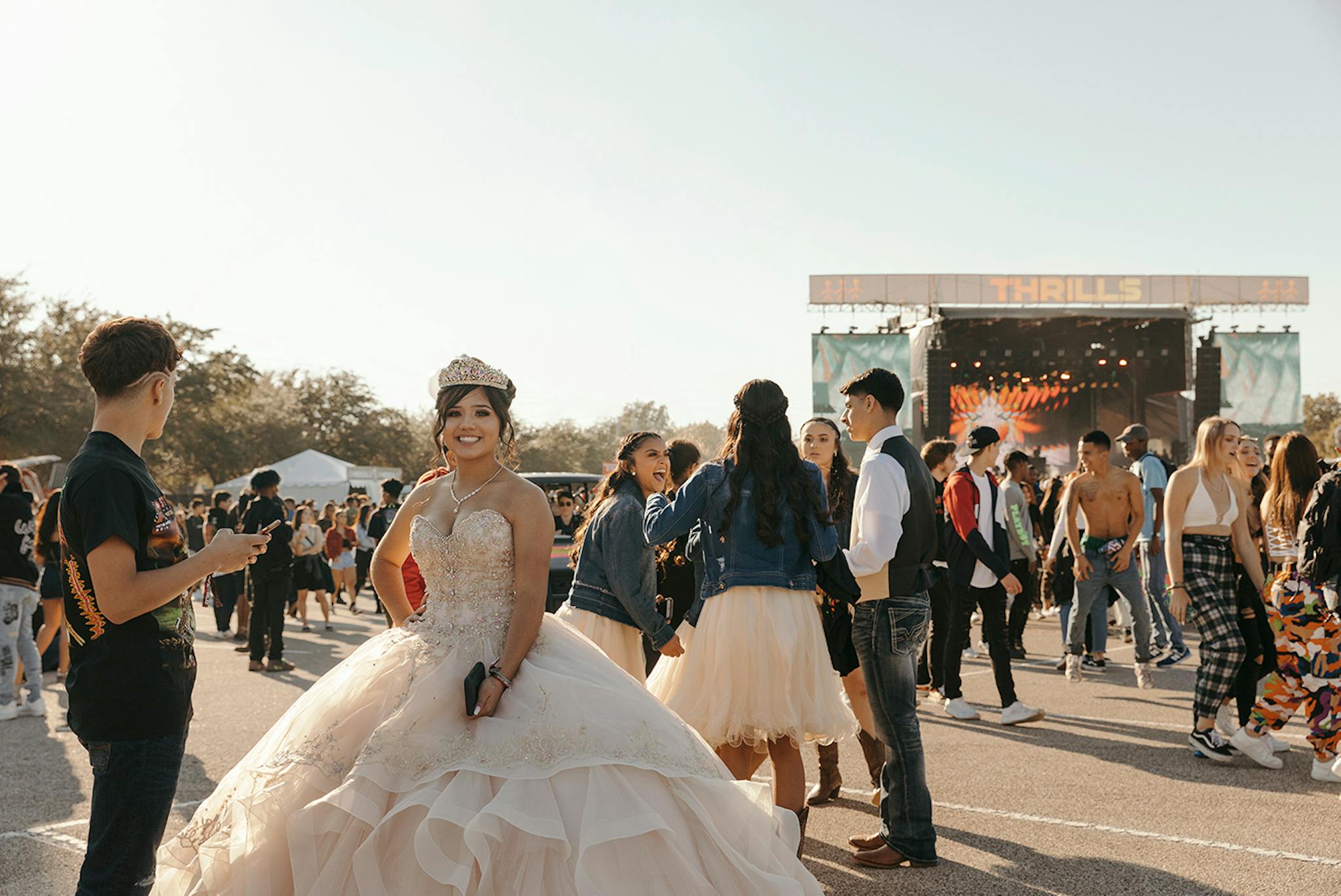 A girl in her quinceñera dress in front of a stage at Astroworld.