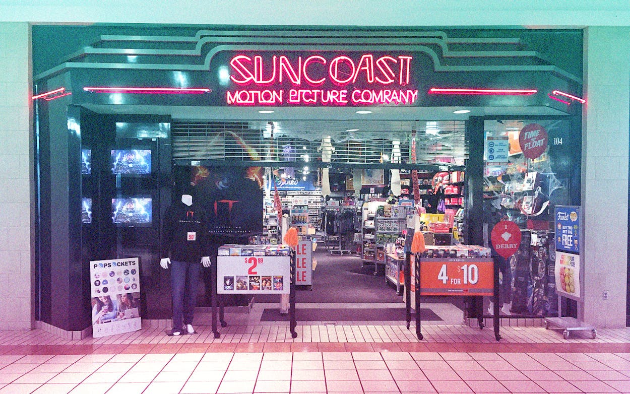 Suncoast film company storefront neon sign.