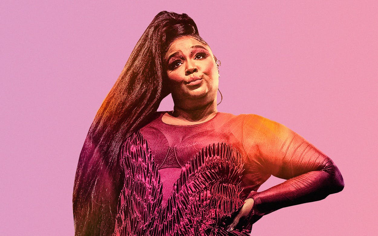 lizzo with pursed lips and hand on her hip against a pink background.